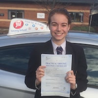 Molly Bishop celebrating her perfect zero first time practical test pass holding up her certificate