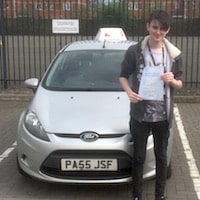 Rob Graham proudly holding his Practical Driving Test certificate after passing