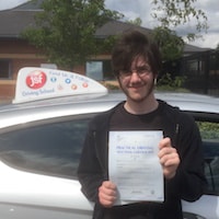 Dylan – Jim #3 200 New driver Dylan Humphrey proudly displaying his practical driving test pass certificate standing outside the JSF school car.