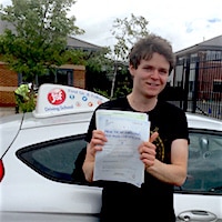 Adam Roberts – Jim #3 200,jpg New driver Adam Roberts showing his practical test pass certificate standing beside the JSF Driving School car