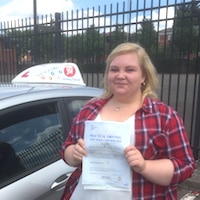 Kat Frost- Jim #6 200 New driver Kat Frost proudly holding her test pass certificate standing beside the JSF Driving School car