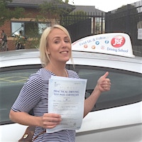 Sinead Childs – Jim #3 200 Smiling new driver Sinead Childs holding her practical driving test pass certificate whilst standing next to the JSF Driving School car