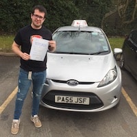 Michael Kelly – Jim #3 200 Michael Kelly proudly holding his practical driving test pass certificate whilst standing next to a JSF Driving School car