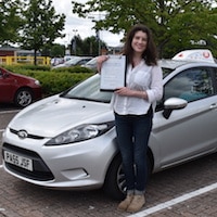 Adele Franghiadi driving test pass Adele Franghiadi holding her driving test pass certificate next to the JSF Driving School car