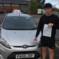 New-Driver-Gloucester-Hartpury-Jake-Bailey-JSF-Driving-School-lo-res New driver Jake Bailey holding his pass certificate next to the JSF Driving School car